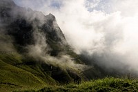 Mist surrounds a green terraced slope of a mountain. Original public domain image from Wikimedia Commons
