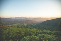 A lush tropical valley against a setting sun. Original public domain image from Wikimedia Commons