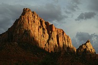 An impressive sandstone rock formation casting long shadows on a cloudy evening. Original public domain image from Wikimedia Commons