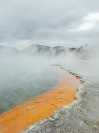 A haze over an orange flat-rock coast. Original public domain image from <a href="https://commons.wikimedia.org/wiki/File:Misty_orange_coastline_(Unsplash).jpg" target="_blank" rel="noopener noreferrer nofollow">Wikimedia Commons</a>