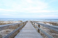 Wooden bridge on the beach, sea side walk. Original public domain image from Wikimedia Commons