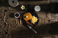 Rustic breakfast tablescape with pancakes, eggs, and bacon. Original public domain image from Wikimedia Commons