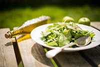 Bowl of fresh salad greens with apple and olive oil. Original public domain image from Wikimedia Commons