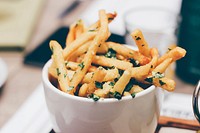 Cup of truffle french fries with herbs and garlic at a restaurant. Original public domain image from Wikimedia Commons