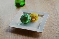Yellow and green french macarons on a square plate. Original public domain image from Wikimedia Commons