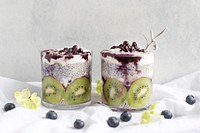 Cups of yogurt parfaits with fresh kiwi, chia seeds, and blueberries. Original public domain image from Wikimedia Commons