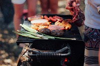 A charcoal grill with meat, burgers, hot dogs, and asparagus at a BBQ. Original public domain image from Wikimedia Commons