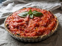 A tart with tomato sauce and basil on top. Original public domain image from Wikimedia Commons