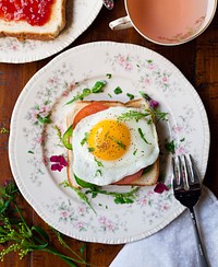 Breakfast toast with fried egg, tomato, and herbs. Original public domain image from Wikimedia Commons