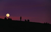 Moon on purple sky, silhouettes people. Original public domain image from Wikimedia Commons