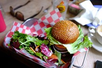 Hamburger sandwich and salad greens at an American fast food restaurant. Original public domain image from Wikimedia Commons