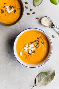 Bowls of orange squash soup topped with feta cheese and herbs. Original public domain image from <a href="https://commons.wikimedia.org/wiki/File:Autumn_Soup_(Unsplash).jpg" target="_blank" rel="noopener noreferrer nofollow">Wikimedia Commons</a>