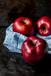 Red apples wrapped in towels. Original public domain image from Wikimedia Commons