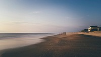 Blurry landscape capture of people doing early during sunrise at a beach in Rodanthe Pier. Original public domain image from Wikimedia Commons