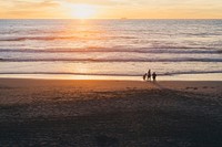 Family by the waves of Great Highway beach during sunset as their child plays with sand. Original public domain image from Wikimedia Commons