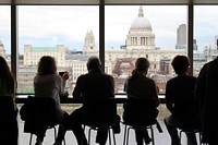 People sitting at a table at a café with a view on St. Paul's Cathedral in London. Original public domain image from Wikimedia Commons