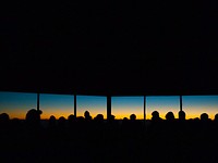 Silhouette of people standing inside Haleakala Observatory watching the sunset through the windows. Original public domain image from <a href="https://commons.wikimedia.org/wiki/File:Haleakala_Observatory,_Kula,_United_States_(Unsplash).jpg" target="_blank" rel="noopener noreferrer nofollow">Wikimedia Commons</a>