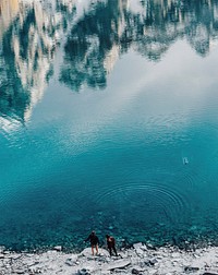 People by the shore of a beautiful lake. Original public domain image from Wikimedia Commons