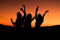 Silhouette of a group of friends celebrating in an orange sunset. Original public domain image from <a href="https://commons.wikimedia.org/wiki/File:Orange_sunset_celebration_(Unsplash).jpg" target="_blank" rel="noopener noreferrer nofollow">Wikimedia Commons</a>
