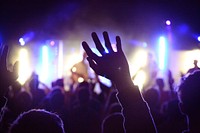 Band members in yellow lights with audience cheering. Original public domain image from Wikimedia Commons