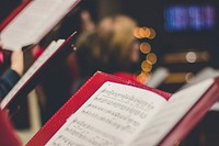 A close-up of a music score in a red leather case with bokeh effect in the background. Original public domain image from Wikimedia Commons