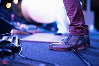 Musician's brown leather shoes on stage. Original public domain image from Wikimedia Commons