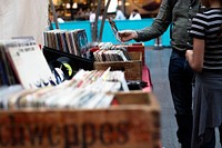 A man and a child browsing vinyl records from vintage boxes. Original public domain image from Wikimedia Commons