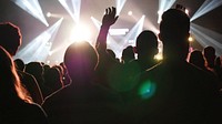 Silhouette of people cheering near the stage. Original public domain image from Wikimedia Commons