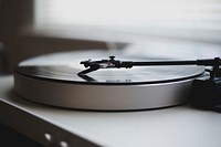 A close-up of a vinyl record played on a record player. Original public domain image from Wikimedia Commons