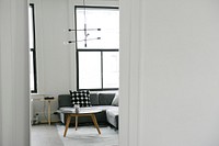 A cozy interior with large windows and a coffee table next to a sofa. Original public domain image from Wikimedia Commons