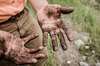 A man with his hands covered with mud. Original public domain image from Wikimedia Commons