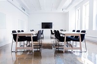 A boardroom with several tables and a television on the wall. Original public domain image from <a href="https://commons.wikimedia.org/wiki/File:Tables_in_a_boardroom_(Unsplash).jpg" target="_blank" rel="noopener noreferrer nofollow">Wikimedia Commons</a>