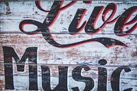 A graffiti sign on a worn-out wooden wall reads “Live Music”. Original public domain image from <a href="https://commons.wikimedia.org/wiki/File:Live_Music_graffiti_sign_(Unsplash).jpg" target="_blank" rel="noopener noreferrer nofollow">Wikimedia Commons</a>