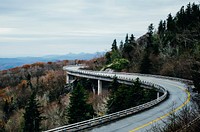 Curvy gray concrete road. Original public domain image from <a href="https://commons.wikimedia.org/wiki/File:Blue_Ridge_Parkway,_Linville,_United_States_(Unsplash).jpg" target="_blank">Wikimedia Commons</a>