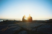 A couple sitting in a rocky valley on Cadillac Mountain watching the sunset over the lake. Original public domain image from <a href="https://commons.wikimedia.org/wiki/File:Cadillac_Mountain_sunset_(Unsplash).jpg" target="_blank" rel="noopener noreferrer nofollow">Wikimedia Commons</a>