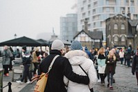 Romantic couple traveling together walks in an embrace through a quaint town. Original public domain image from Wikimedia Commons