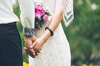 Bride with pink bouquet and lace dress hold hands with groom. Original public domain image from Wikimedia Commons