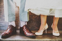 Shoes of a bride and groom illuminated under soft light. Original public domain image from Wikimedia Commons