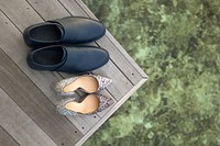 A man and woman's shoes from above on a wooden table. Original public domain image from Wikimedia Commons