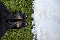 Bride wearing lace dress faces groom wearing black pants and shoes. Original public domain image from <a href="https://commons.wikimedia.org/wiki/File:Bride_and_groom_on_grass_(Unsplash).jpg" target="_blank" rel="noopener noreferrer nofollow">Wikimedia Commons</a>
