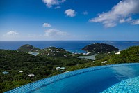 A round infinity pool on a green coast on a bright day. Original public domain image from Wikimedia Commons