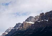 A side view of snow covered mountains with large clouds in Canada. Original public domain image from <a href="https://commons.wikimedia.org/wiki/File:Snow_covered_mountains_in_Canada_(Unsplash).jpg" target="_blank">Wikimedia Commons</a>