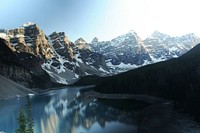 The Moraine Lake is showing a reflection of the snowcapped mountains surrounding it. Original public domain image from Wikimedia Commons