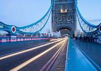 An urban bridge before dusk with headlight and tail light trails from passing traffic. Original public domain image from Wikimedia Commons