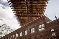 A brick building under the ramp of the Brooklyn Bridge in New York City. Original public domain image from Wikimedia Commons