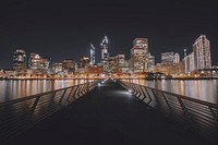 A look down Pier 14 with cityscape lighting reflections in the surrounding water. Original public domain image from Wikimedia Commons