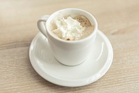 Espresso with whipped cream in a white mug on a white saucer with a light wooden table underneath. Original public domain image from <a href="https://commons.wikimedia.org/wiki/File:Espresso_with_whipped_cream_(Unsplash).jpg" target="_blank" rel="noopener noreferrer nofollow">Wikimedia Commons</a>
