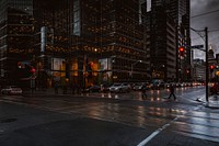 Silhouettes of pedestrians crossing a wet street in Toronto. Original public domain image from <a href="https://commons.wikimedia.org/wiki/File:Dark_town_(Unsplash).jpg" target="_blank" rel="noopener noreferrer nofollow">Wikimedia Commons</a>