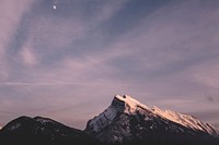 Moon on a cloudy sky over the mountains at Banff. Original public domain image from <a href="https://commons.wikimedia.org/wiki/File:Moonrise_(Unsplash).jpg" target="_blank" rel="noopener noreferrer nofollow">Wikimedia Commons</a>