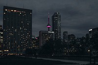 A dim cityscape of Toronto with the CN tower lit up in purple. Original public domain image from <a href="https://commons.wikimedia.org/wiki/File:Toronto_night_cityscape_(Unsplash).jpg" target="_blank" rel="noopener noreferrer nofollow">Wikimedia Commons</a>